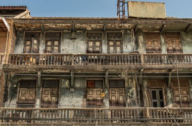 Balkonlarda ahşap pencereli ve ahşap kapılı eski binanın dış yüzeyi zamanla bozulmaya bırakılmış. Çin mimarisi tarzı, Eski ev, özellikle odak noktası yok..