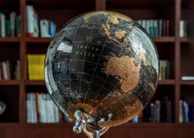 Chiang Rai,Thailand - Sep 06, 2020 : Replica globe on the background of bookshelves in library. Selective focus.