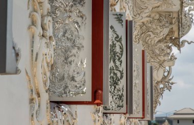 Chiang Rai, Thailand - Sep 05, 2020 : Elaborate sculptures of windows at the famous Wat Rong Khun (White Temple) in Chiang Rai, Thailand. Selective Focus.