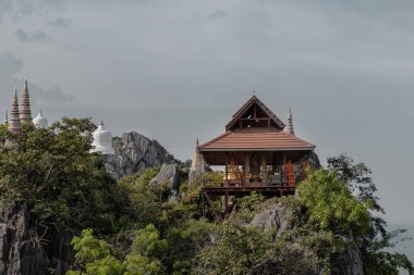 Lampang, Thailand - Sep 03, 2020 : Pagoda on top of the cliff high mountain at Chaloem Phrakiat Phrachomklao Rachanuson temple (Wat Phrabat Pu Pha Daeng) Chae-Hom District, Lampang province, Unseen and Amazing temple in Thailand. Selective focus. clipart