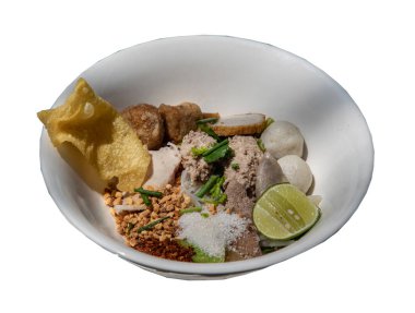 Geleneksel buharda pişirilmiş ince pirinç eriştesi (küçük erişte) balık köftesi, karides köftesi, haşlanmış domuz eti, kızarmış wonton, suger, yer fıstığı, kurutulmuş acı biber ve limonsuz beyaz fonda beyaz arka planda izole edilmiş beyaz kasede çorbasız limon. 