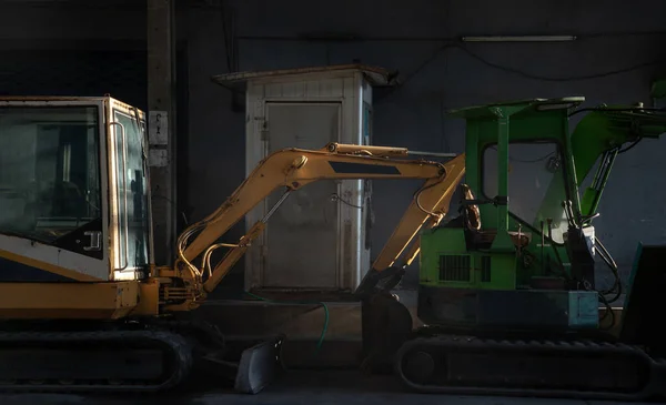 Two Construction Excavators Yellow Green Color Construction Site Parked Finishing — Stock Fotó