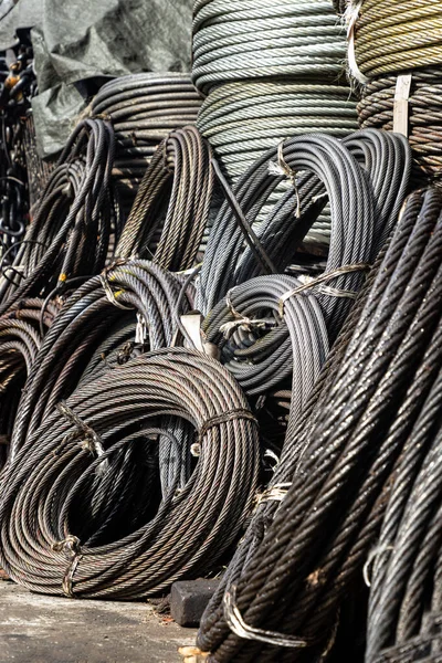 Coil large Wire rope sling or Cable sling drum reels stocked in store. Steel wire cable or rope for heavy industrial use, Wire rope texture, Selective Focus.