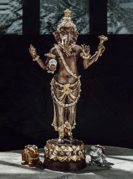 Bronze figurine of Lord ganesha and Mushika statue mouse (Rat of Lord Ganesha amulet). Ganesha is hindu god of Success that artists and people worship, Copy space, Selective focus.