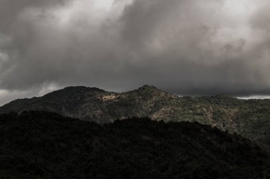 Amazing flowing morning fog mountains range in background with sunlight clouds and sky. Natural summer landscape, No focus, specifically.