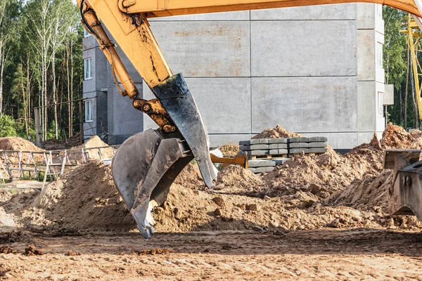 Excavator bucket close up. Excavation work at construction site and road construction. Construction machinery