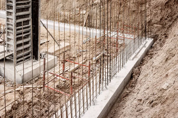 base plate. pit formation of grillage is completed. Forms formwork vertical structures of lower level underground parking. Raft foundation is top pile, pier foundation. Home construction