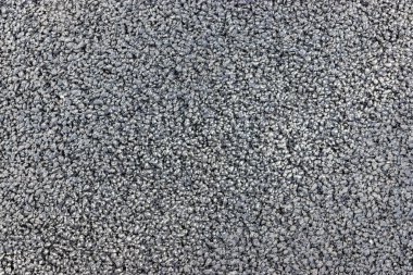 Düz koyu gri asfalt kaplama doku küçük kayalar ile