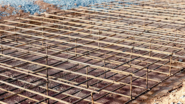 Spatial reinforcement of the floor and foundation with reinforcement. Preparing the foundation for pouring concrete. Industrial construction site