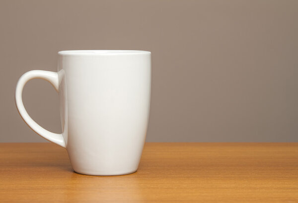 White mug on wooden table