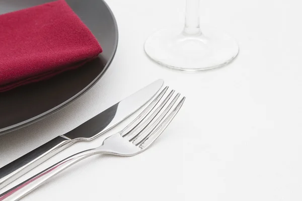 Black plate place setting with glass — Stock Photo, Image