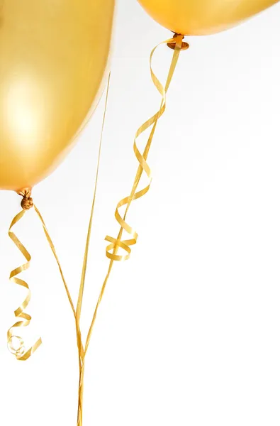 Gold balloons and ribbon — Stock Photo, Image