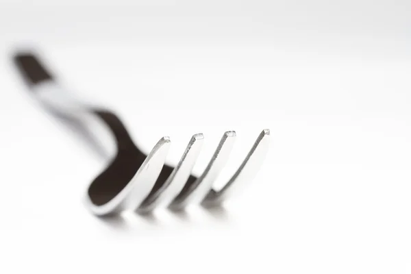 Metal dining fork on white background shallow depth of field — Stock Photo, Image