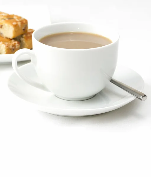 Taza de té caliente con pasteles en un plato — Foto de Stock