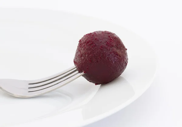 Beetroot on a fork on white plate — Stock Photo, Image