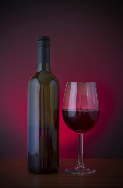 Low key vignette image of red wine in glass with bottle — Stock Photo, Image