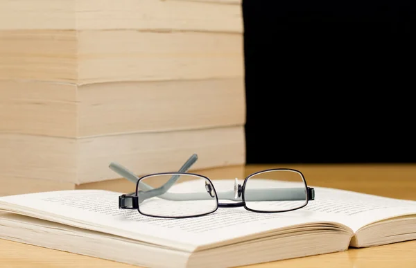 Pile of books with glasses