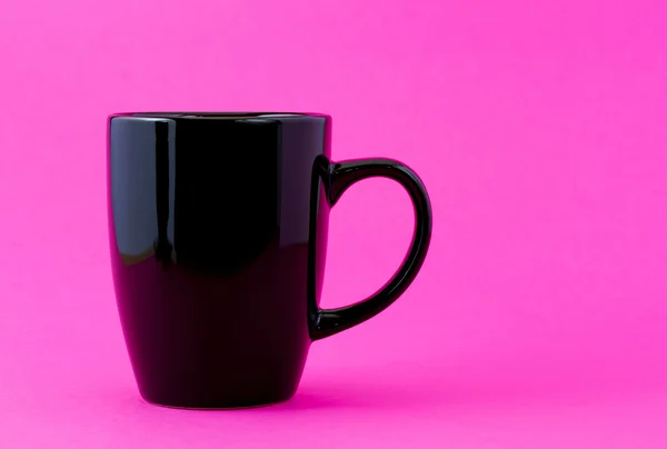 Mug hitam pada latar belakang merah muda — Stok Foto