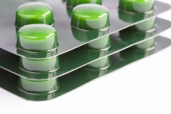 Stack of green pills in blister packs — Stock Photo, Image