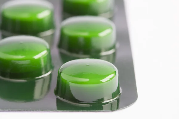 Green pills in a blister pack — Stock Photo, Image