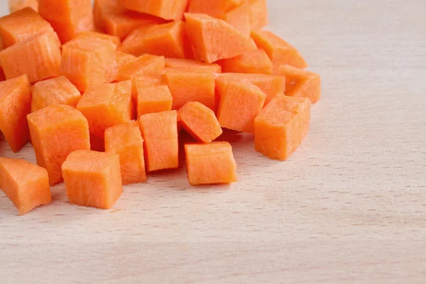Diced raw carrots on a chopping board — Stock Photo, Image