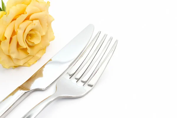 Dinner place setting. Knife and fork with yellow rose on white — Stock Photo, Image