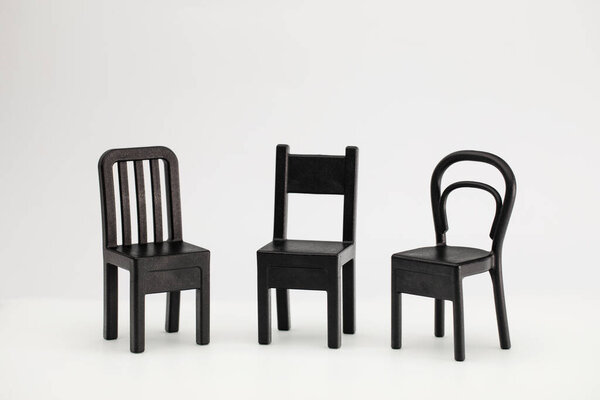 Three black chairs on a white background