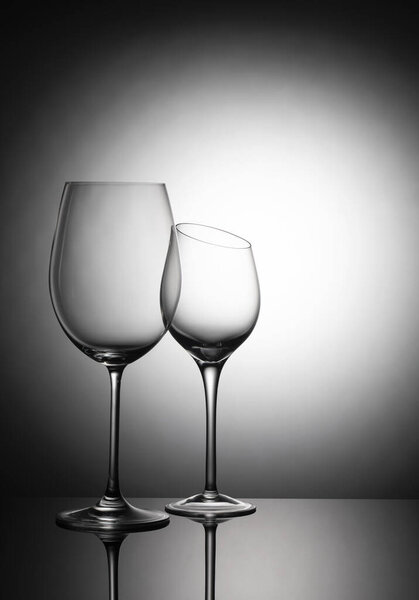 Two glass goblets on a gradient background