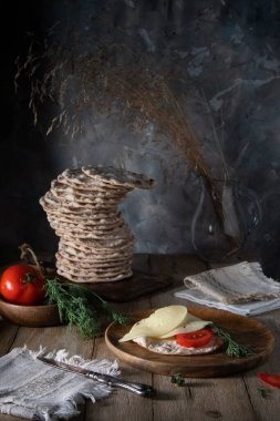 Sandwich with polarkncke cheese and herbs on a rustic table