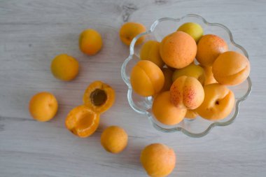 Apricot fruit background in a bowl on wooden table