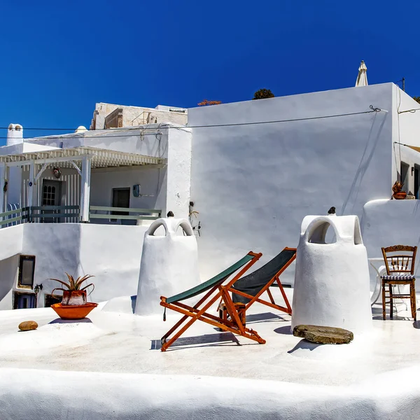 stock image A sun terrace for rest with a wooden sunbed on a traditional greek white house