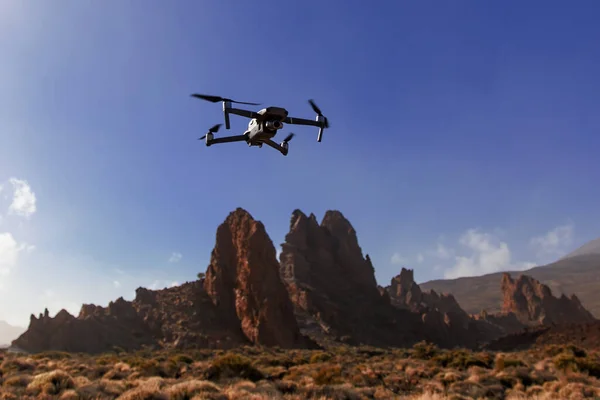 stock image Folding small drone is flying over the mountains