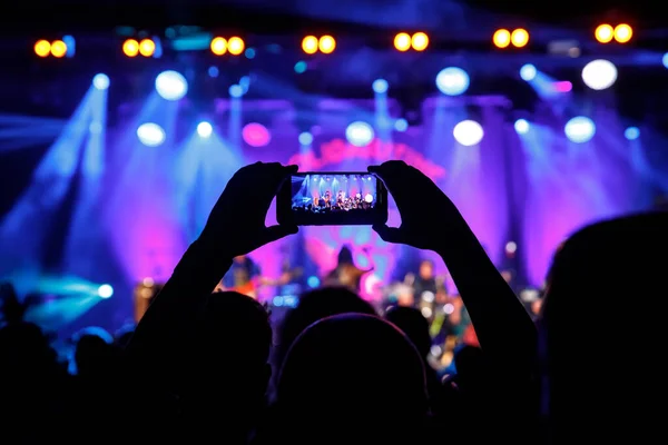 Photo for social network at concert. Mobile phone on music show