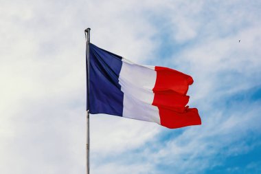 French flag on blue cloudy aky background