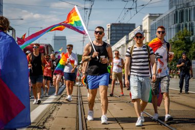 Varşova, Polonya - 25.06.2022: Eşitlik geçidi, gökkuşağı bayraklı mutlu renkli insanlar