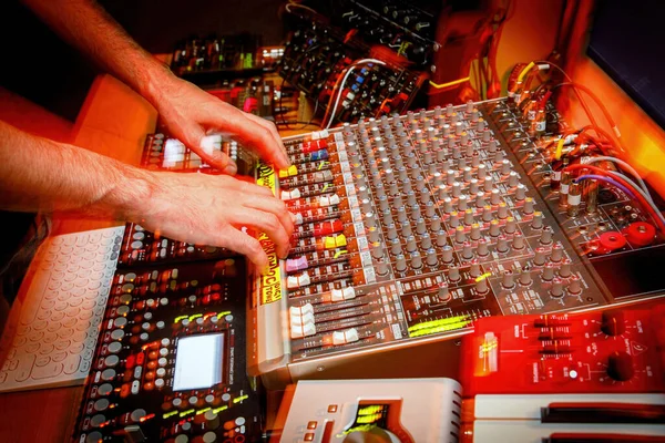 Hands of the sound manager on the music console