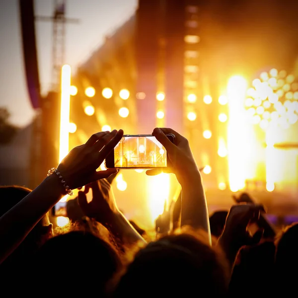 Taking photos of the concert stage, live concert, and music festival due to mobile phone