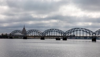 Railway arch bridge under dramatic clouds