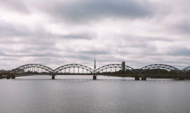 Railway arch bridge under dramatic clouds