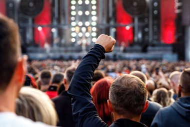 People with raised hands during the music concert