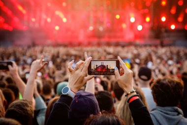 Recording a concert using a mobile phone. Smartphone at music show