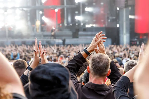 People with raised hands during the music concert