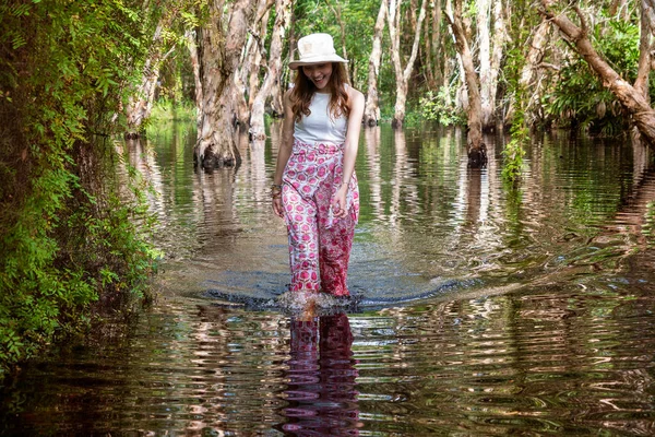 Beautiful Asian tourists come to walk in the water, jump in the lake, there is a forest, a national park, a forest.