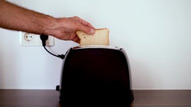 man preparing toast for breakfast