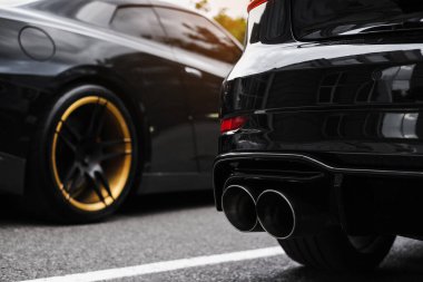 exhaust pipe of a black sports car close-up