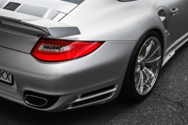 headlight and wheel of silver Porsche 911