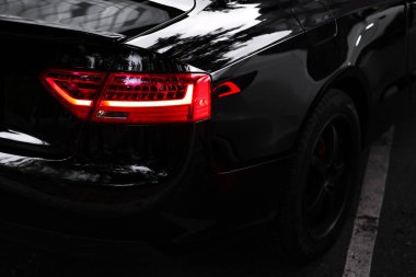 taillight of a black supercar close-up