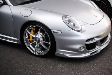 headlight and wheel of silver Porsche 911 Odessa, Ukraine July 2022