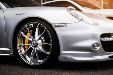 headlight and wheel of silver Porsche 911 Odessa, Ukraine July 2022