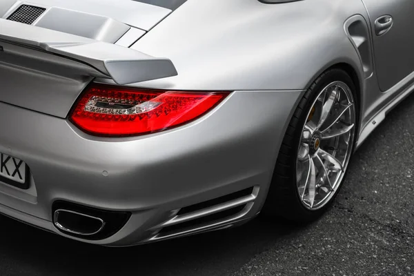 headlight and wheel of silver Porsche 911